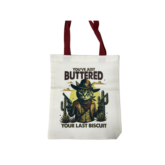 “You’ve Just Buttered Your Last Biscuit” Cowboy Cat | Canvas 14x13 Tote Bag
